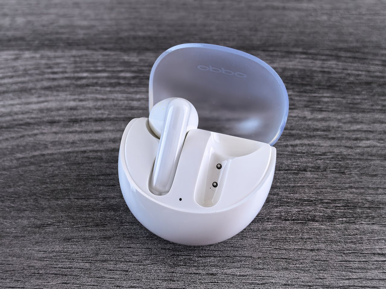Stylish white wireless earbuds with a sleek case on a modern wooden background.